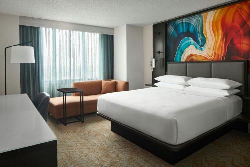 a hotel room with a bed and a couch at Falls Church Marriott Fairview Park in Falls Church