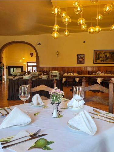 a dining room with a table with a white table cloth at Hotel Posada San Rafael in Pátzcuaro