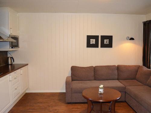 a living room with a couch and a table at Grimstad Vertshus in Grimstad