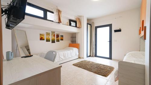 a large white room with a bed and a window at Villa Xenia in Pizzo