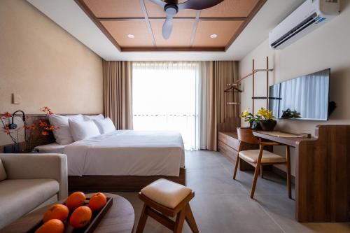 a hotel room with a bed and a living room at REFUEL NEST Boutique Hotel in Danang