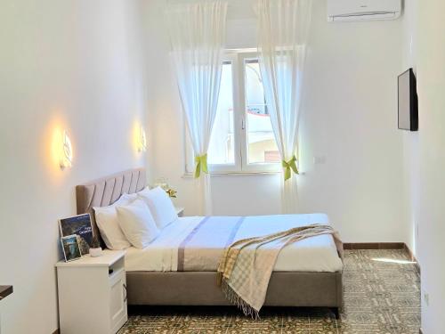a bedroom with a bed and a window at Home Julia in Massa Lubrense