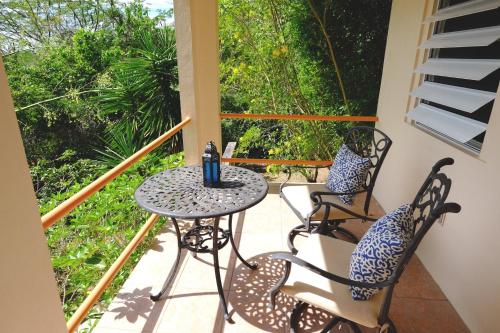 a patio with a table and chairs on a balcony at Oreanda in Colonia Puerto Real