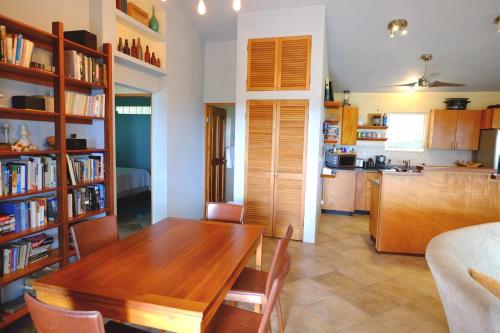 a living room with a wooden table and a kitchen at Oreanda in Colonia Puerto Real