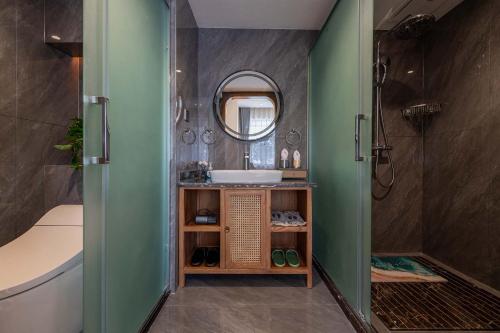 a bathroom with a sink and a mirror at MOUNT WELL RESORT HOTEL in Lijiang