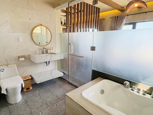 a bathroom with a sink and a shower and a toilet at SUNSHINE BEACH Resort in Mui Ne
