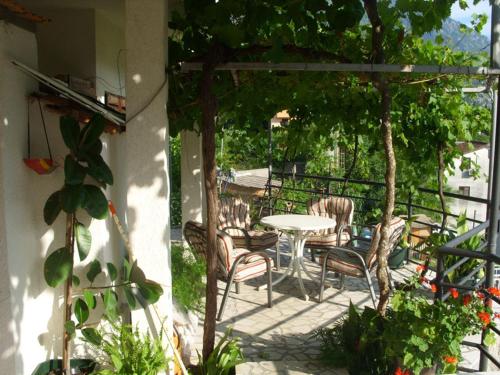 a patio with a table and chairs on a balcony at Apartments Dakovic in Kotor