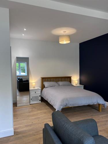 a bedroom with a bed and a couch at Sycamore Stay in Spalding