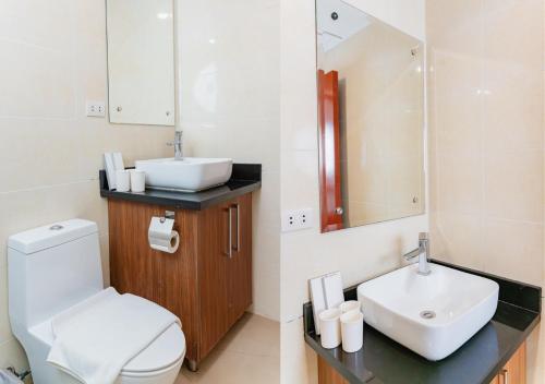 a bathroom with a white toilet and a sink at Cris Inn Tagum in Tagum