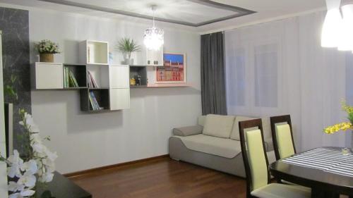 a living room with a couch and a table at City Charm Warszawa in Warsaw