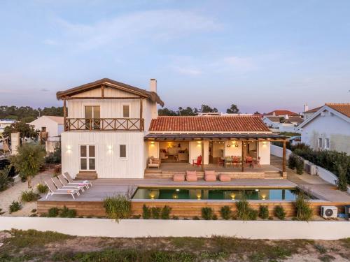 a house with a swimming pool in front of a house at Casa Terracotta with Private Pool in Comporta