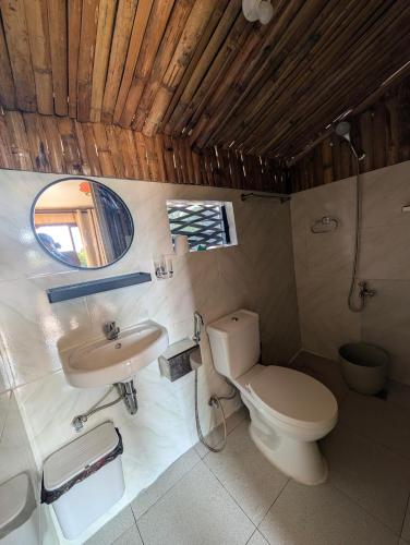 a bathroom with a toilet and a sink at Jadens Guesthouse in Siquijor