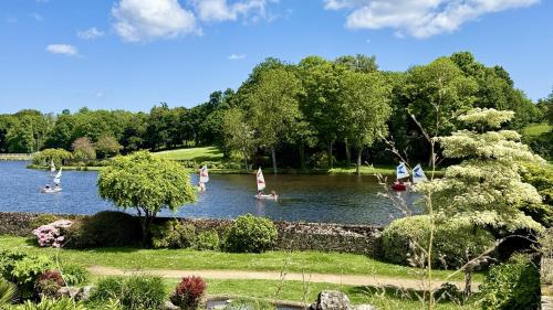a lake with people on boats in the water at La Bonne Etoile in Châtelaudren