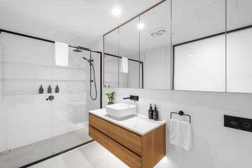 a bathroom with a sink and a shower at Kove Apartment - G01 in Kiama
