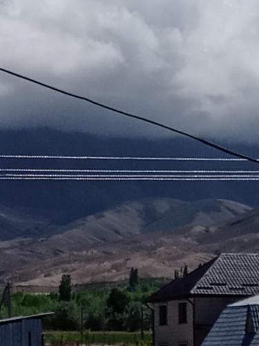 a view of the mountains from a power line at Тумар дом in Tamga