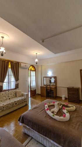a bedroom with a large bed in a room at Yakamoz Hotel Fethiye in Fethiye
