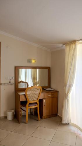 a desk with a mirror and a chair in a room at Yakamoz Hotel Fethiye in Fethiye