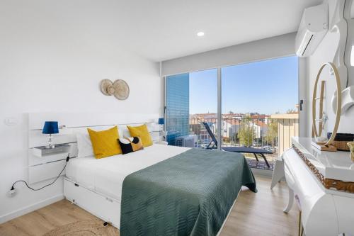 a bedroom with a bed and a large window at Blue Breeze Espinho | Pool View, Gym & Balcony in Espinho