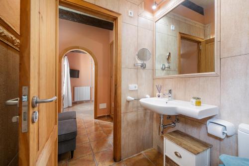 a bathroom with a sink and a mirror at Finca - Agroturisme Sa Parellada in Binibona
