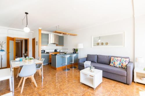 a living room with a couch and a table at Aguda Beach Apartment in Arcozelo
