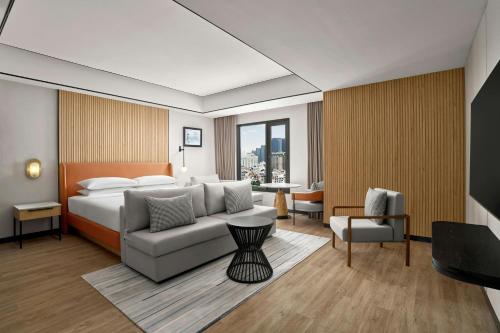 a hotel room with a bed and a couch at Sheraton Hanoi Hotel in Hanoi