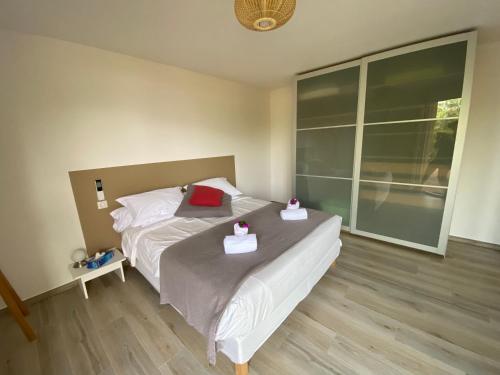 a bedroom with a bed with two boxes on it at Casa Léna in Propriano