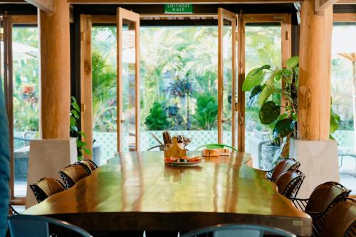 a wooden table in a room with a large window at Villa Xiav - Flipside Adventures in Bản Kin