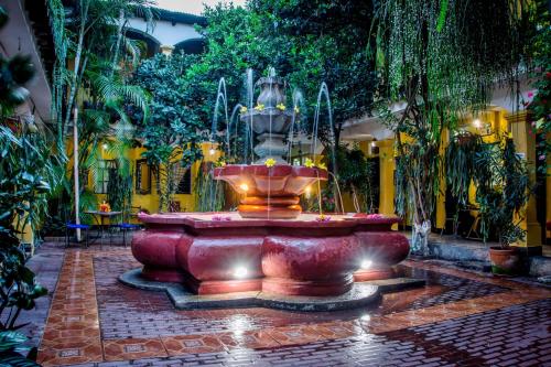 a large fountain in the middle of a courtyard at Posada San Vicente by AHS in Antigua Guatemala