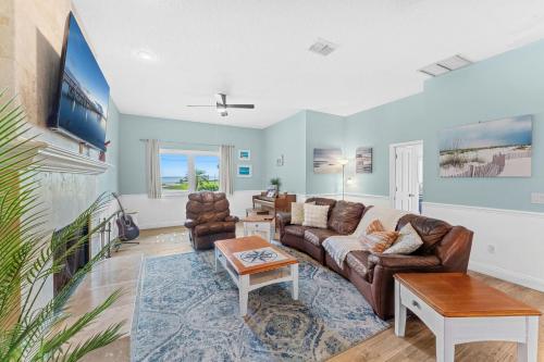 a living room with a couch and a tv at 5665 S. Tropical Trail in Merritt Island