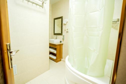 a bathroom with a shower and a sink at As-Salam Boutique Hotel in Bukhara