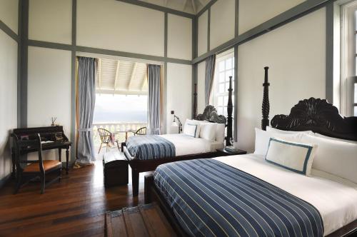 A bed or beds in a room at Belle Mont Sanctuary Resort - Kittitian Hill