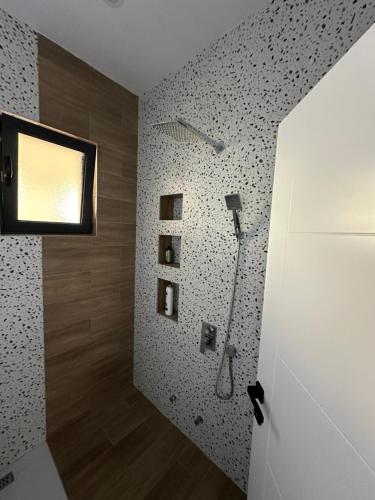 a bathroom with a shower in a wall at Miri Apartments in Ulcinj