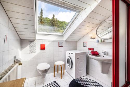 a bathroom with a washing machine and a sink at Studio Wacholderheide in Albstadt