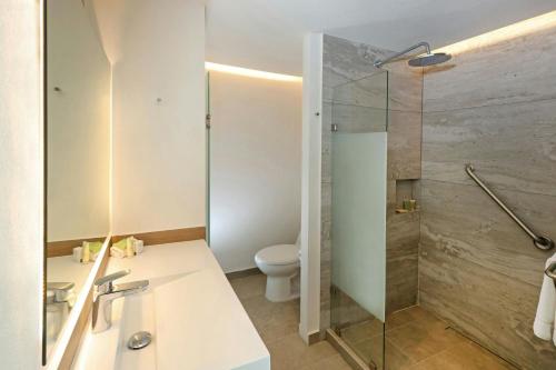 a bathroom with a shower and a toilet at City Express Plus by Marriott Mexicali in Mexicali