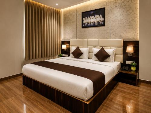 a bedroom with a large bed in a room at Hotel Karma Inn Near Akshay Patra Jagatpura in Jaipur