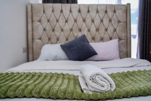 a bed with two towels and pillows on it at Royalty homes in Kiambu