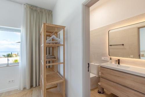 a bathroom with a wooden shelf next to a sink at Glück House In Las Norias in Las Manchas