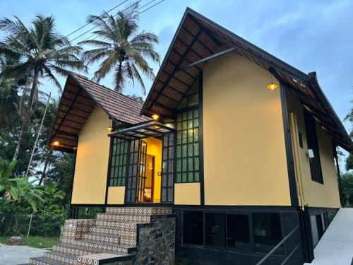 a house with a staircase leading up to it at Casa Kabani Resort in Chegāt