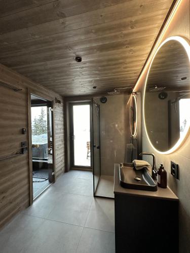 a bathroom with a sink and a mirror at Hafjell Luxury Lodge in Øyer