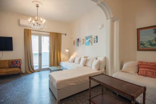 a living room with a couch and a table at SunWave Residence in Agios Nikolaos
