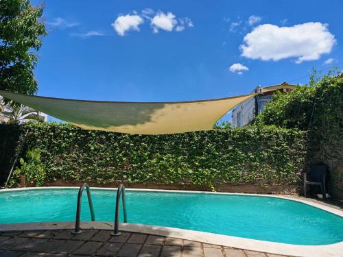 a hammock hanging over a swimming pool at Hotel Alcántara Boutique in San Salvador