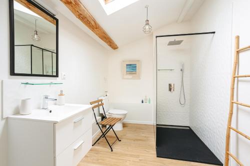 a bathroom with a sink and a shower at Opaline à la Rochelle in Vergné