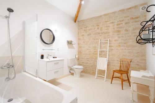 a bathroom with a sink toilet and a mirror at Ambre à la Rochelle in Vergné