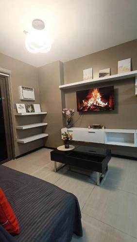 a living room with a fireplace in the wall at Suite City view in Manila