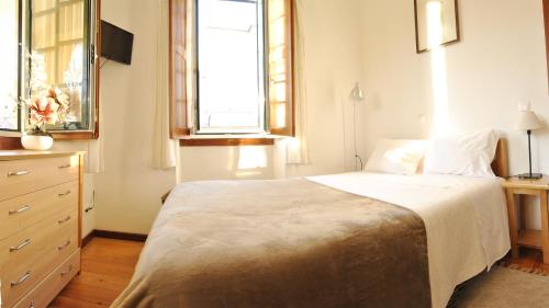 Un pat sau paturi într-o cameră la Hospedaria Cafe Pielas