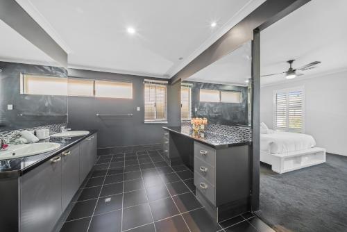 a bathroom with two sinks and a large mirror at Garrison Cottage in The Vines