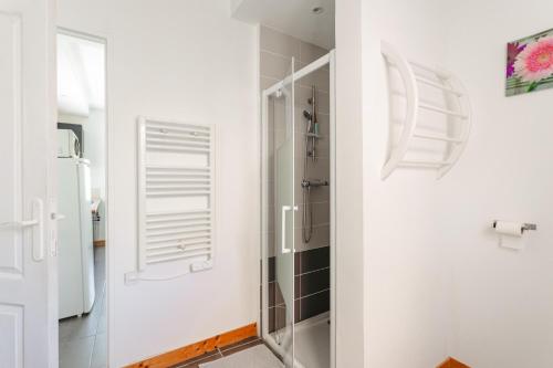 a bathroom with a shower with a glass door at Gite Les Jardins d'Harmonie in Bourgneuf