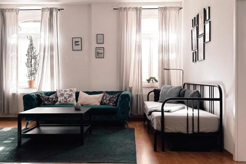 a living room with a couch and a table at City Retreat Zwickau mit Balkon zum Innenhof in Zwickau