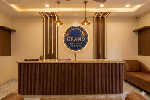 a lobby with a grand entrance sign on the wall at Hotel Shumo Grand Khammam in Khammam