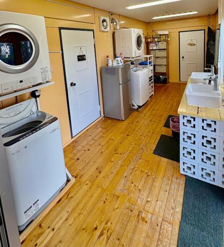 a room with a kitchen with a washer and dryer at 民宿あわい in Nakijin
